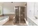 Modern bathroom showcasing a glass shower, soaking tub, and white vanity at 288 Pine Way, Dallas, GA 30157