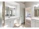Well-lit bathroom featuring dual vanity sinks and an elegant mirror at 288 Pine Way, Dallas, GA 30157