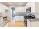 Modern kitchen featuring granite countertops, stainless steel appliances, and white cabinetry at 288 Pine Way, Dallas, GA 30157