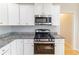 Well-equipped kitchen featuring granite countertops, stainless steel appliances, and ample storage at 288 Pine Way, Dallas, GA 30157