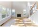 Bright living room with a fireplace, large windows, and elegant hardwood floors at 288 Pine Way, Dallas, GA 30157