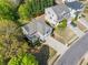 Beautiful home's aerial shot with a well-kept lawn, long driveway, and lush surrounding trees in a suburban neighborhood at 3835 New Salem Ct, Cumming, GA 30040