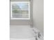 Bright bathroom featuring a modern bathtub with chrome fixtures and a window providing natural light at 3835 New Salem Ct, Cumming, GA 30040