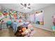 Bright bedroom with ceiling fan and a charming collection of plush animals at 3835 New Salem Ct, Cumming, GA 30040