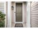 Close up view of a home's front door with welcome mat and decorative lighting at 3835 New Salem Ct, Cumming, GA 30040