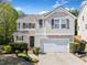 Charming two-story home features a manicured lawn and a two car garage at 3835 New Salem Ct, Cumming, GA 30040