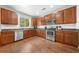 Well-lit kitchen features wood cabinets and modern appliances at 3835 New Salem Ct, Cumming, GA 30040