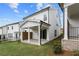 Charming backyard with a covered patio, lush green lawn, and privacy fencing at 685 Summitt Hill Way, Cumming, GA 30040