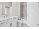 Well-lit bathroom featuring a tiled shower, modern vanity, and stylish fixtures at 685 Summitt Hill Way, Cumming, GA 30040