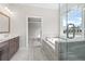 Modern bathroom featuring a glass shower, soaking tub, and a dual sink vanity at 685 Summitt Hill Way, Cumming, GA 30040
