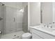 Modern bathroom featuring a glass-enclosed shower, white tile, and sleek fixtures at 685 Summitt Hill Way, Cumming, GA 30040