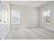 A light and airy bedroom with soft carpet and ample natural light from two windows at 685 Summitt Hill Way, Cumming, GA 30040