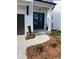 Home entrance featuring beautiful landscaping, colorful flowers, and a paved walkway at 685 Summitt Hill Way, Cumming, GA 30040