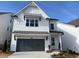 Charming two-story home featuring a gray garage door and a well-manicured front yard at 685 Summitt Hill Way, Cumming, GA 30040