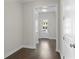 Inviting hallway featuring hardwood floors and natural light streaming through the glass front door at 685 Summitt Hill Way, Cumming, GA 30040