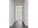 Hallway view showcasing access to the bedrooms and living spaces with hardwood floors at 685 Summitt Hill Way, Cumming, GA 30040