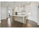 Open kitchen layout with large island, pendant lighting, and stainless appliances at 685 Summitt Hill Way, Cumming, GA 30040