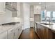 Well-equipped kitchen boasting stainless steel appliances, granite countertops, and an island with sink at 685 Summitt Hill Way, Cumming, GA 30040