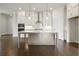 Spacious kitchen features a central island, stainless steel appliances, and designer pendant lighting at 685 Summitt Hill Way, Cumming, GA 30040