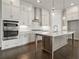 Bright kitchen featuring granite countertops, an island with a sink, and stainless steel appliances at 685 Summitt Hill Way, Cumming, GA 30040