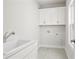 Bright laundry room with white cabinets, a sink, and space-saving design for efficient household tasks at 685 Summitt Hill Way, Cumming, GA 30040