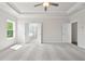 Bright main bedroom with modern ceiling fan, plush carpet, and ensuite bathroom at 685 Summitt Hill Way, Cumming, GA 30040