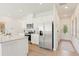 Modern kitchen with stainless steel appliances, white cabinetry, and granite countertops at 1000 Sutherland Lane (Lot 35), Lawrenceville, GA 30043