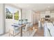 Bright dining area showcasing a wooden table, stylish chairs, and lots of natural light from the large windows at 1020 Sutherland Lane (Lot 41), Lawrenceville, GA 30043