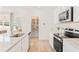 Bright, modern kitchen featuring stainless steel appliances, granite countertops, and pantry for ample storage at 1020 Sutherland Lane (Lot 41), Lawrenceville, GA 30043