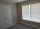 Neutral bedroom with a window and closet, offering a cozy and functional space at 1234 Pinedale Nw Cir, Conyers, GA 30012