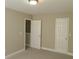Clean, neutral bedroom with carpet, closet, and a door to another room at 1234 Pinedale Nw Cir, Conyers, GA 30012