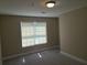 Bedroom with neutral walls and carpet with a window view to the outside at 1234 Pinedale Nw Cir, Conyers, GA 30012