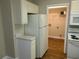 Bright kitchen area featuring white appliances and cabinets, next to a pantry at 1234 Pinedale Nw Cir, Conyers, GA 30012