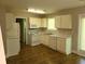 The kitchen with white appliances and cabinets, next to a pantry and access to the deck at 1234 Pinedale Nw Cir, Conyers, GA 30012
