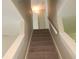 Carpeted staircase leading to the upper level, offering a comfortable transition between floors at 1234 Pinedale Nw Cir, Conyers, GA 30012
