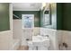 Charming bathroom with white tile, green walls, and a pedestal sink at 1721 Hudson Woods Trl, Decatur, GA 30033