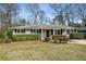 Charming single-story house with a well-maintained lawn and manicured landscaping at 1721 Hudson Woods Trl, Decatur, GA 30033