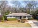 Charming single-story home featuring mature landscaping, a brick facade, and a welcoming entrance at 1721 Hudson Woods Trl, Decatur, GA 30033