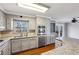 Well-lit kitchen boasting stone countertops, stainless steel appliances, and modern finishes at 1721 Hudson Woods Trl, Decatur, GA 30033