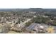 Expansive aerial view showcases a peaceful neighborhood surrounded by mature trees and distant mountain views at 2358 New Salem Trce, Marietta, GA 30064