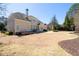 Large backyard featuring a well-maintained lawn, mature trees, a patio, and a hot tub at 2358 New Salem Trce, Marietta, GA 30064