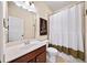 Bathroom featuring a single sink vanity, toilet, decorative mirror, and a shower with curtain at 2358 New Salem Trce, Marietta, GA 30064