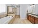 Bright bathroom with double sinks, soaking tub, tiled shower, and modern fixtures at 2358 New Salem Trce, Marietta, GA 30064