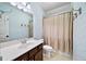 Bathroom featuring blue patterned wallpaper, a single sink vanity, and a shower with a tan curtain at 2358 New Salem Trce, Marietta, GA 30064