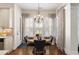 Bright breakfast nook with wood floors, stylish chandelier, and plantation shutters allowing lots of natural light at 2358 New Salem Trce, Marietta, GA 30064