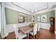 Sophisticated dining room featuring decorative mirrors, stylish chandelier, and hardwood floors at 2358 New Salem Trce, Marietta, GA 30064