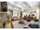 Open-concept living room with hardwood floors, a stone fireplace, and an open view to the kitchen at 2358 New Salem Trce, Marietta, GA 30064