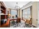 Well-lit home office with custom built-ins, a large desk, and plantation shutters at 2358 New Salem Trce, Marietta, GA 30064