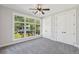 Bright bedroom featuring a large window offering a view of the outdoors, plus ceiling fan and closet at , Atlanta, GA 30310