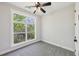 This bedroom offers gray carpet, a large window with natural light, and a ceiling fan at , Atlanta, GA 30310